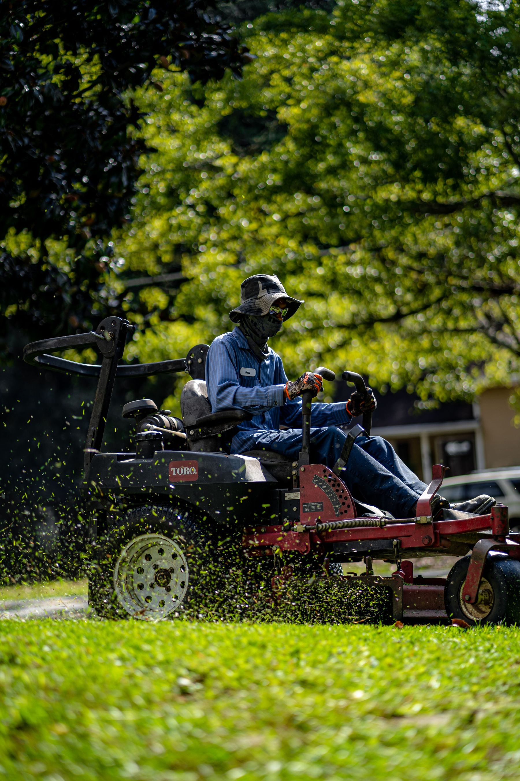 A mower cutting a residential lawn