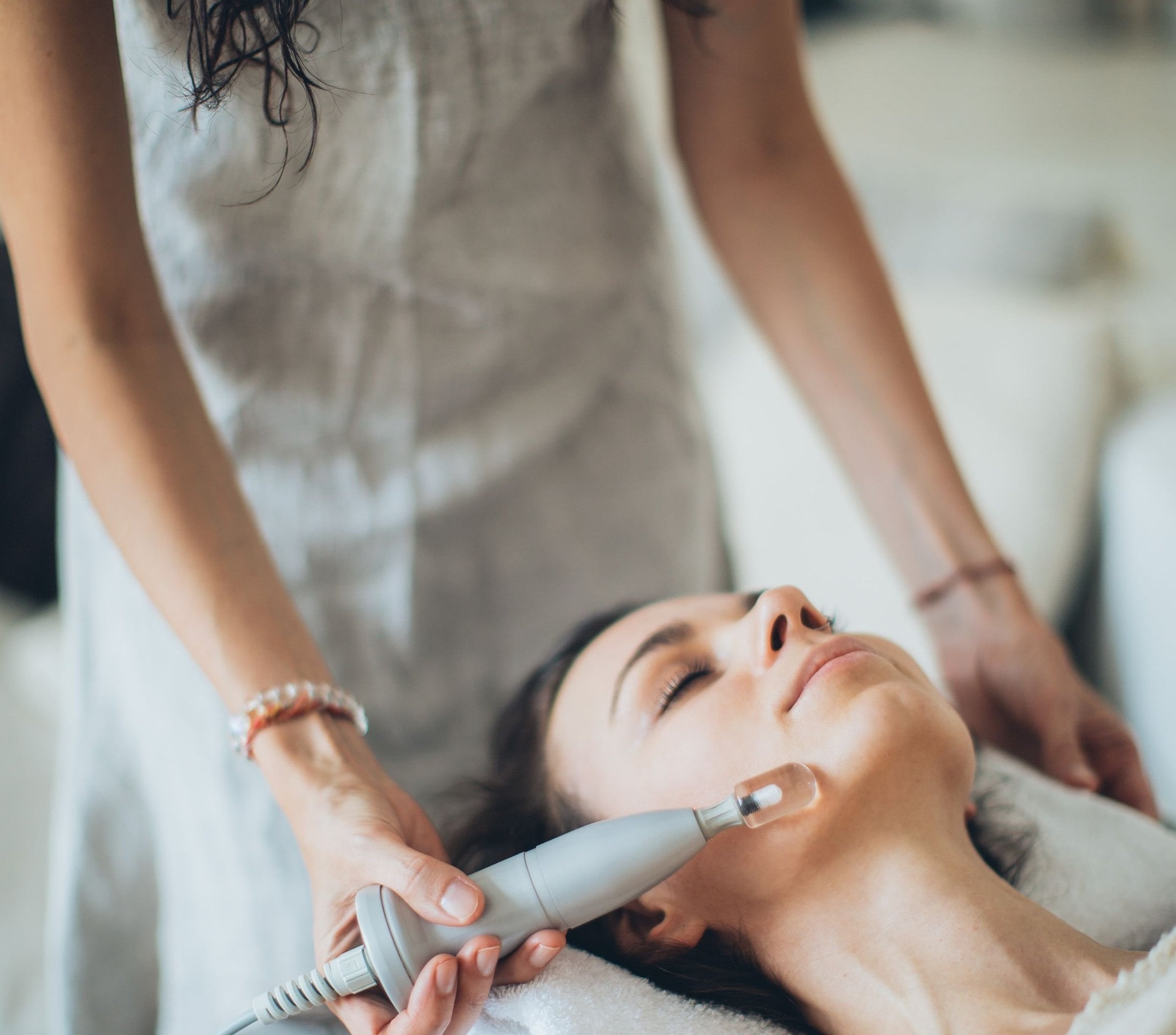 A practitioner giving a facial treatment